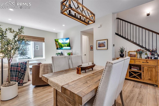 dining space with recessed lighting, stairway, and light wood-style floors