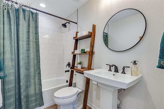 bathroom with toilet and shower / bath combo with shower curtain