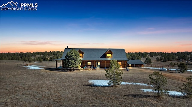 view of front of house with log exterior and fence