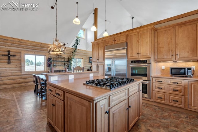 kitchen with light countertops, high vaulted ceiling, a chandelier, and stainless steel appliances