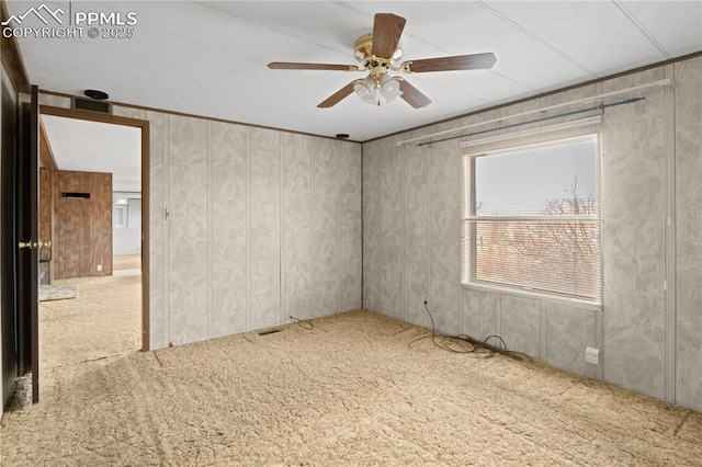 carpeted spare room with ceiling fan