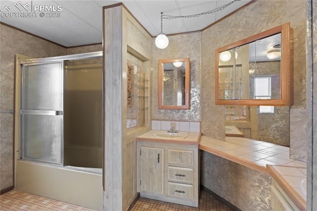 full bath featuring wallpapered walls, enclosed tub / shower combo, ornamental molding, tile patterned floors, and vanity