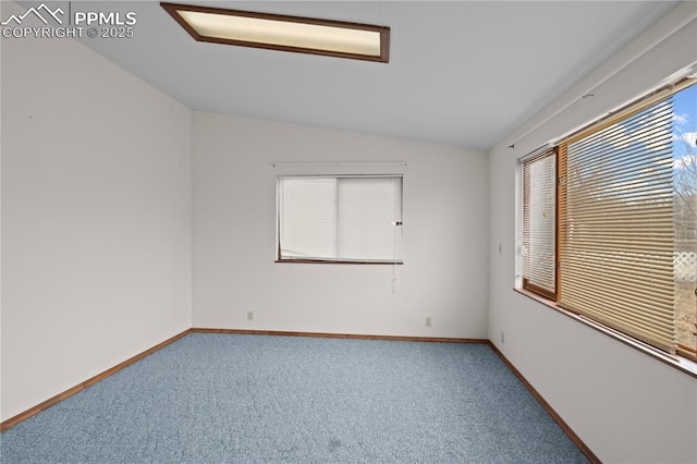 unfurnished room featuring lofted ceiling, carpet floors, and baseboards