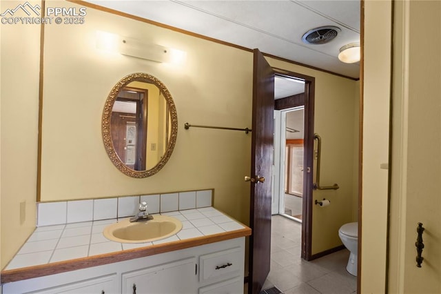 half bathroom featuring toilet, visible vents, crown molding, and vanity