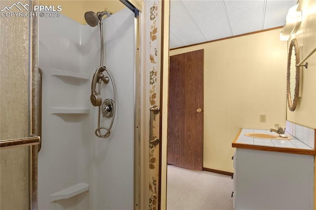 bathroom with ornamental molding, a stall shower, vanity, and tile patterned floors