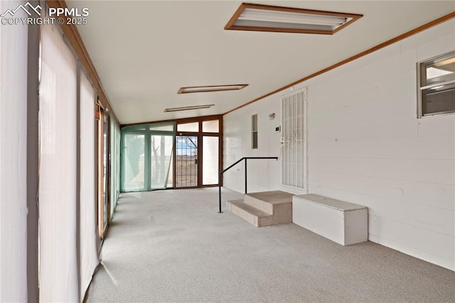 interior space with ornamental molding, expansive windows, and carpet flooring