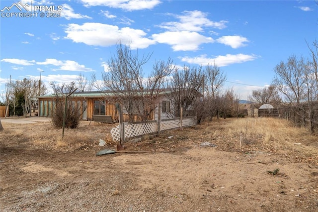 view of side of property with fence