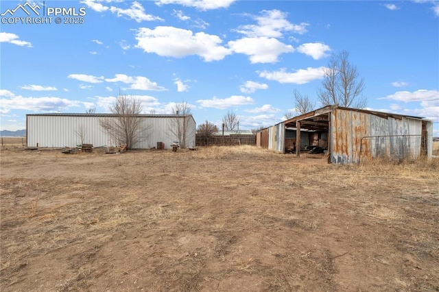 view of yard featuring an outbuilding and a pole building