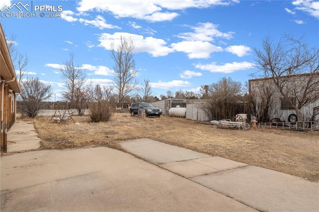 view of yard with fence and a patio