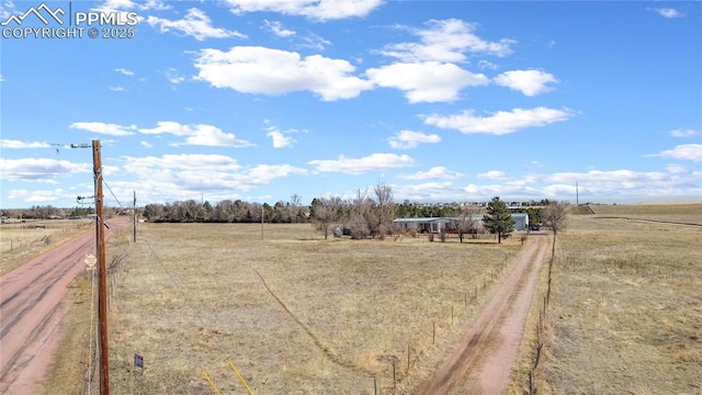 view of yard with a rural view