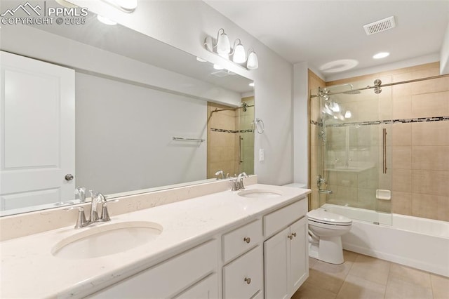 bathroom featuring toilet, tile patterned flooring, visible vents, and a sink