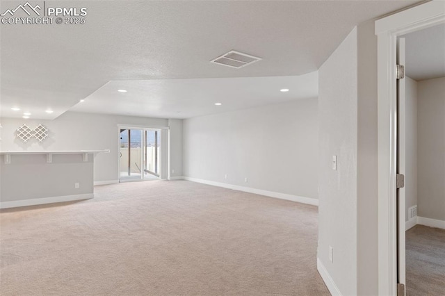 below grade area with recessed lighting, baseboards, visible vents, and light colored carpet