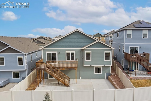 back of house with stairway, a patio area, a fenced backyard, and a residential view