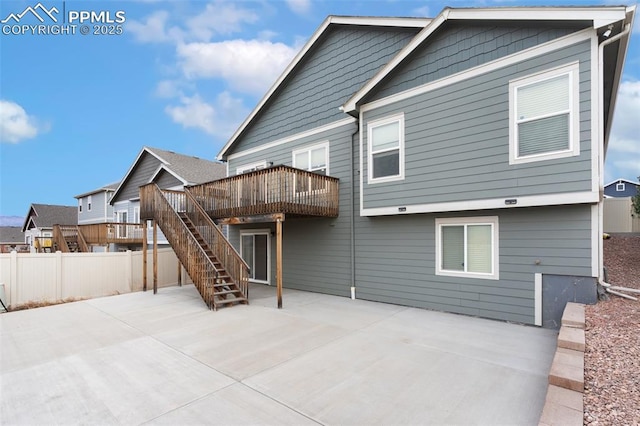 back of house with a patio area, fence, a deck, and stairs