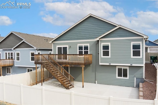 rear view of house featuring a patio area, a fenced backyard, stairs, and a wooden deck