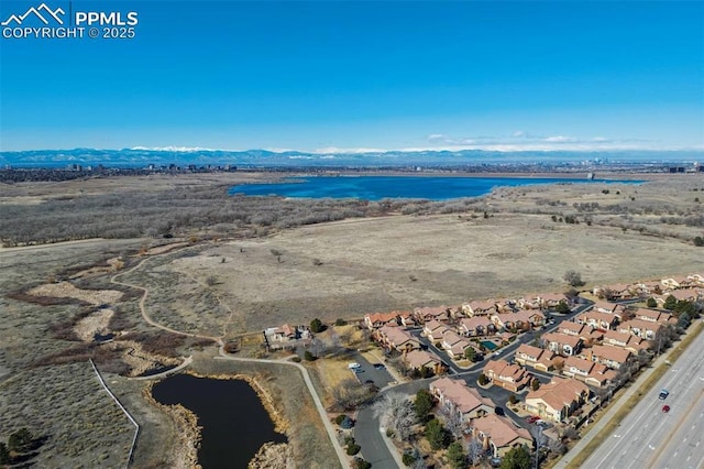 birds eye view of property with a residential view and a water and mountain view