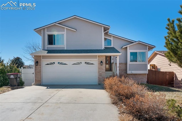 view of front of property featuring driveway, brick siding, an attached garage, and fence