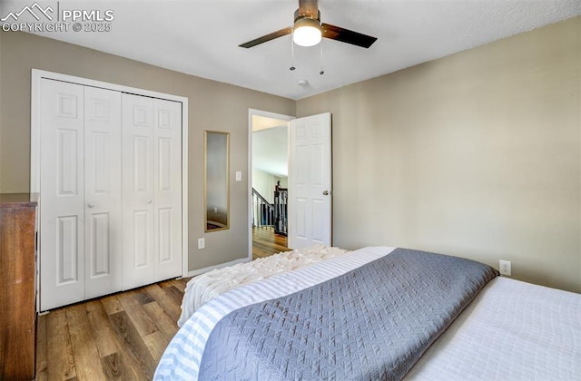 bedroom with a closet, a ceiling fan, and wood finished floors