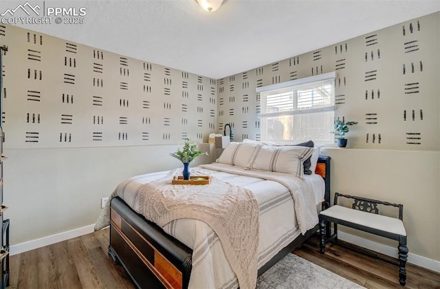 bedroom featuring wood finished floors and baseboards