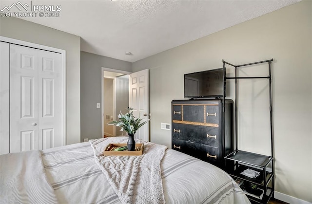 bedroom featuring a closet and baseboards