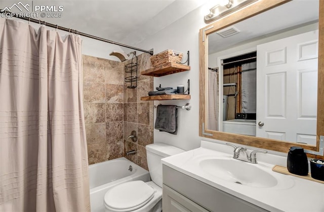 bathroom with visible vents, toilet, washer / clothes dryer, shower / bath combination with curtain, and vanity