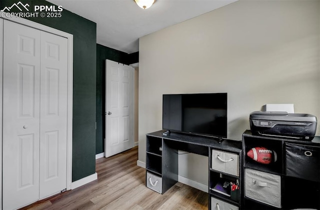 interior space featuring light wood-type flooring and baseboards