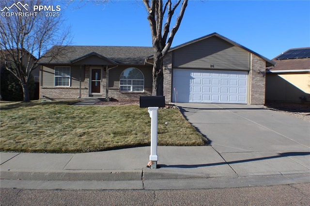 ranch-style house featuring driveway, brick siding, an attached garage, and a front yard