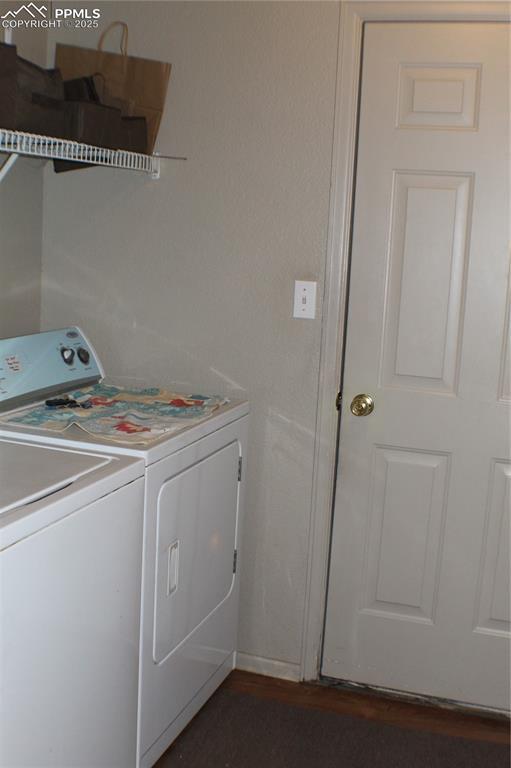 washroom featuring laundry area and washing machine and clothes dryer