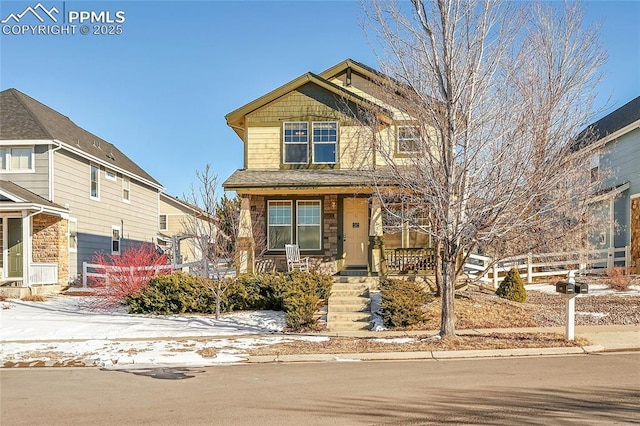 craftsman-style house with covered porch and fence