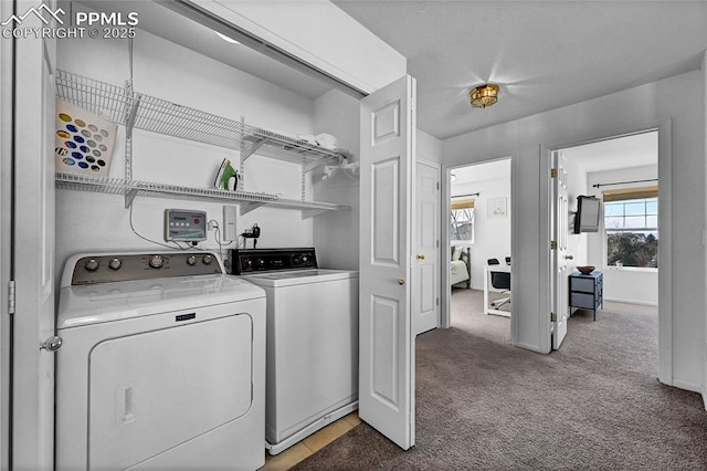 laundry area with baseboards, laundry area, washer and clothes dryer, and light colored carpet