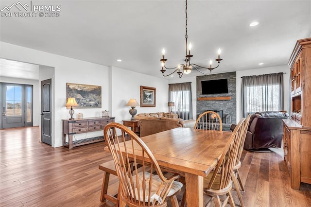 dining area featuring a healthy amount of sunlight, a fireplace, wood finished floors, and recessed lighting