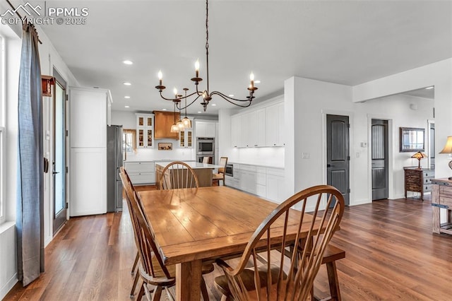 dining room with baseboards, an inviting chandelier, dark wood finished floors, and recessed lighting