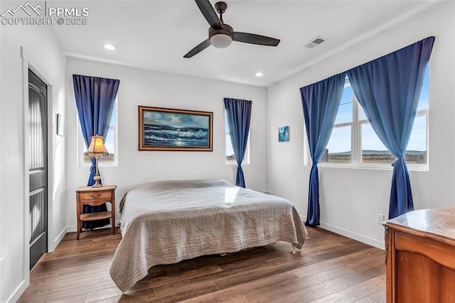 bedroom featuring baseboards, visible vents, and hardwood / wood-style floors