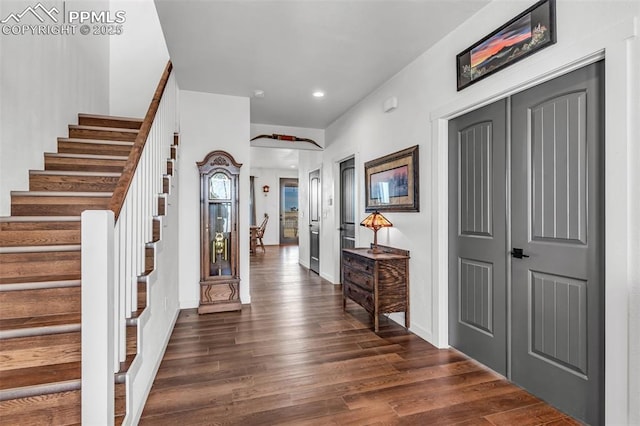 foyer with dark wood-style floors, recessed lighting, baseboards, and stairs