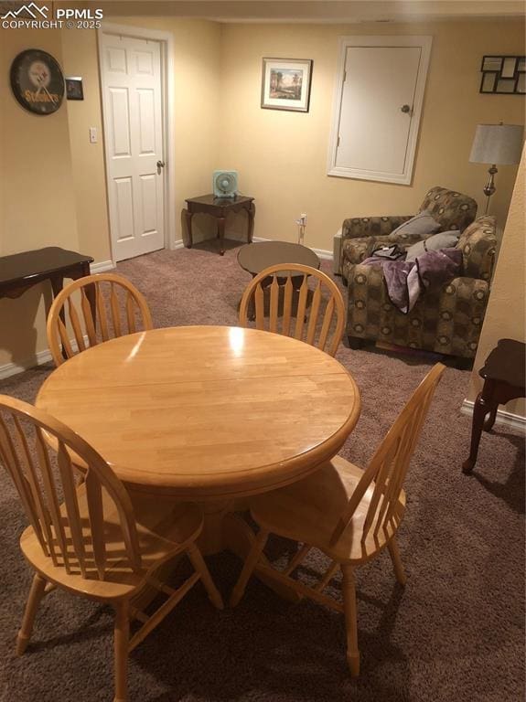 dining space featuring carpet and baseboards