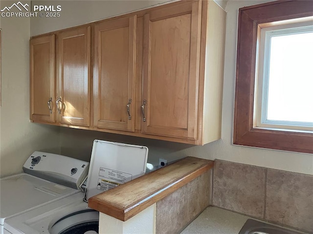 laundry room featuring washer and dryer and cabinet space