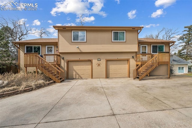 split level home with stairway, driveway, and a garage