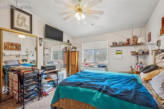 carpeted bedroom featuring lofted ceiling and ceiling fan