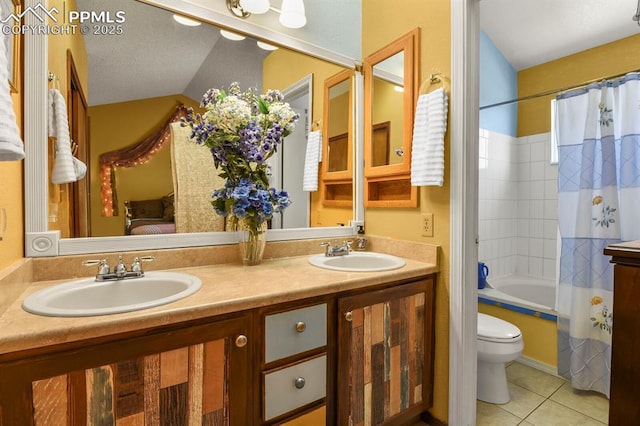 bathroom featuring a sink, double vanity, and tile patterned floors