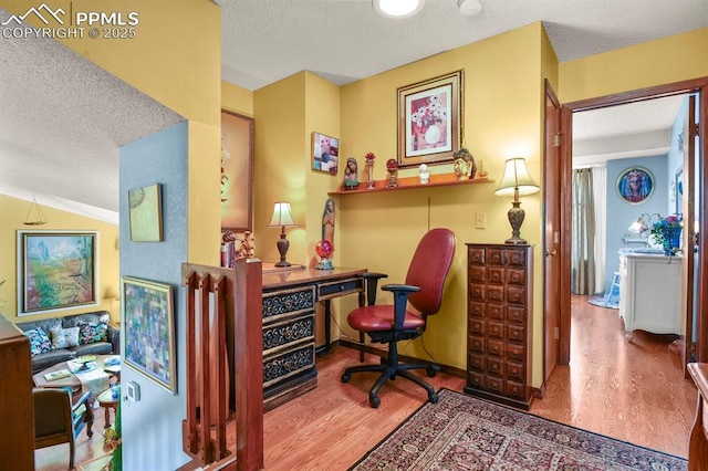 home office featuring a textured ceiling and wood finished floors