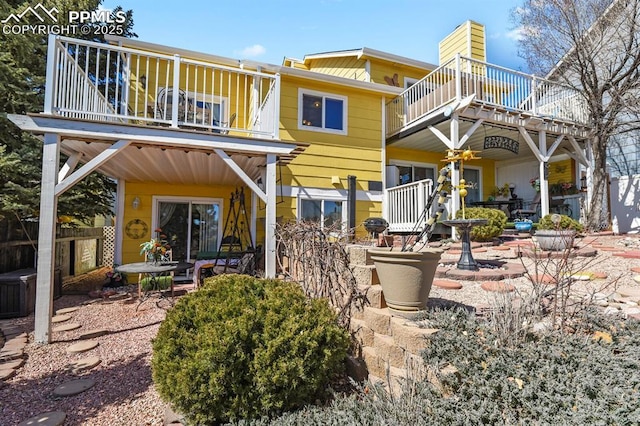 rear view of house featuring a patio area and a balcony