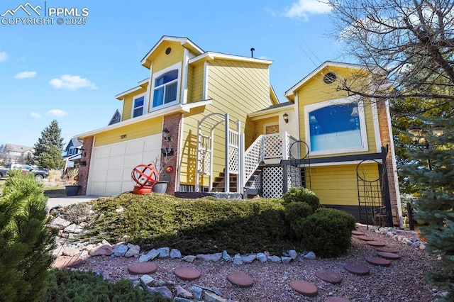 view of front of property featuring stairs, brick siding, and an attached garage