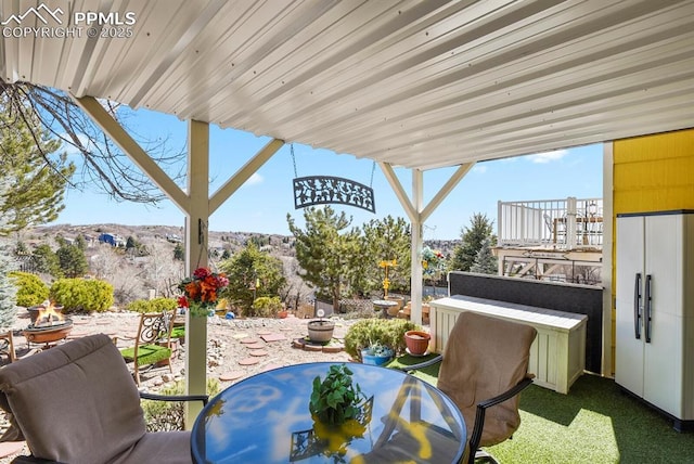 view of patio with an outdoor fire pit and outdoor dining area