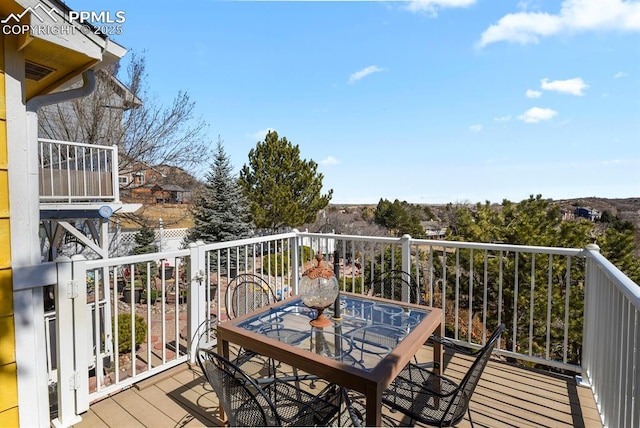 wooden terrace featuring outdoor dining area