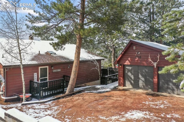 view of snow covered exterior with a garage