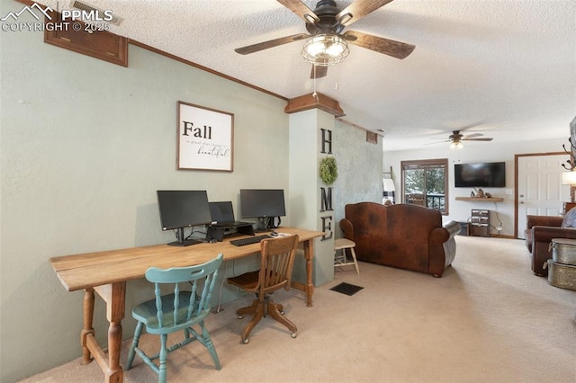 carpeted office featuring a ceiling fan, visible vents, crown molding, and a textured ceiling