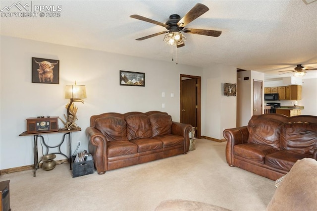 living area featuring baseboards, a textured ceiling, a ceiling fan, and light carpet
