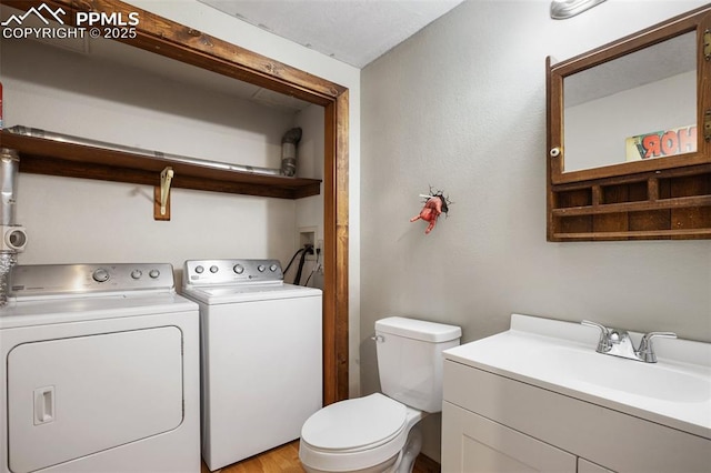 interior space featuring a sink, washer and clothes dryer, and laundry area