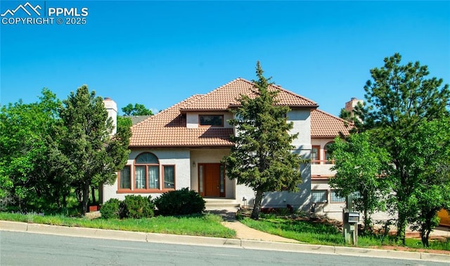 3012 S Electra Dr, Colorado Springs, CO 80906 - mediterranean / spanish-style home with a tiled roof, stucco siding, and a chimney