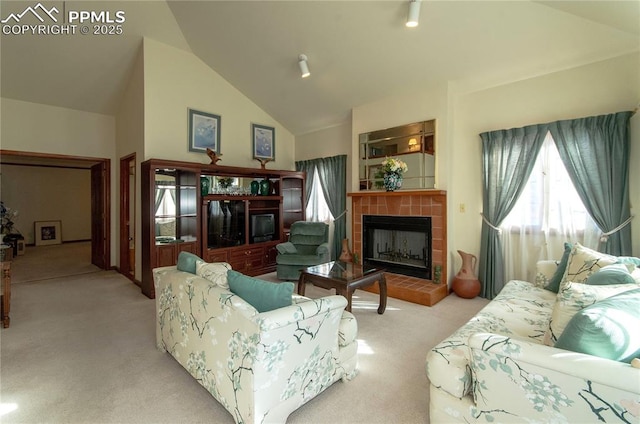 3012 S Electra Dr, Colorado Springs, CO 80906 - living room with a tile fireplace, carpet flooring, and lofted ceiling